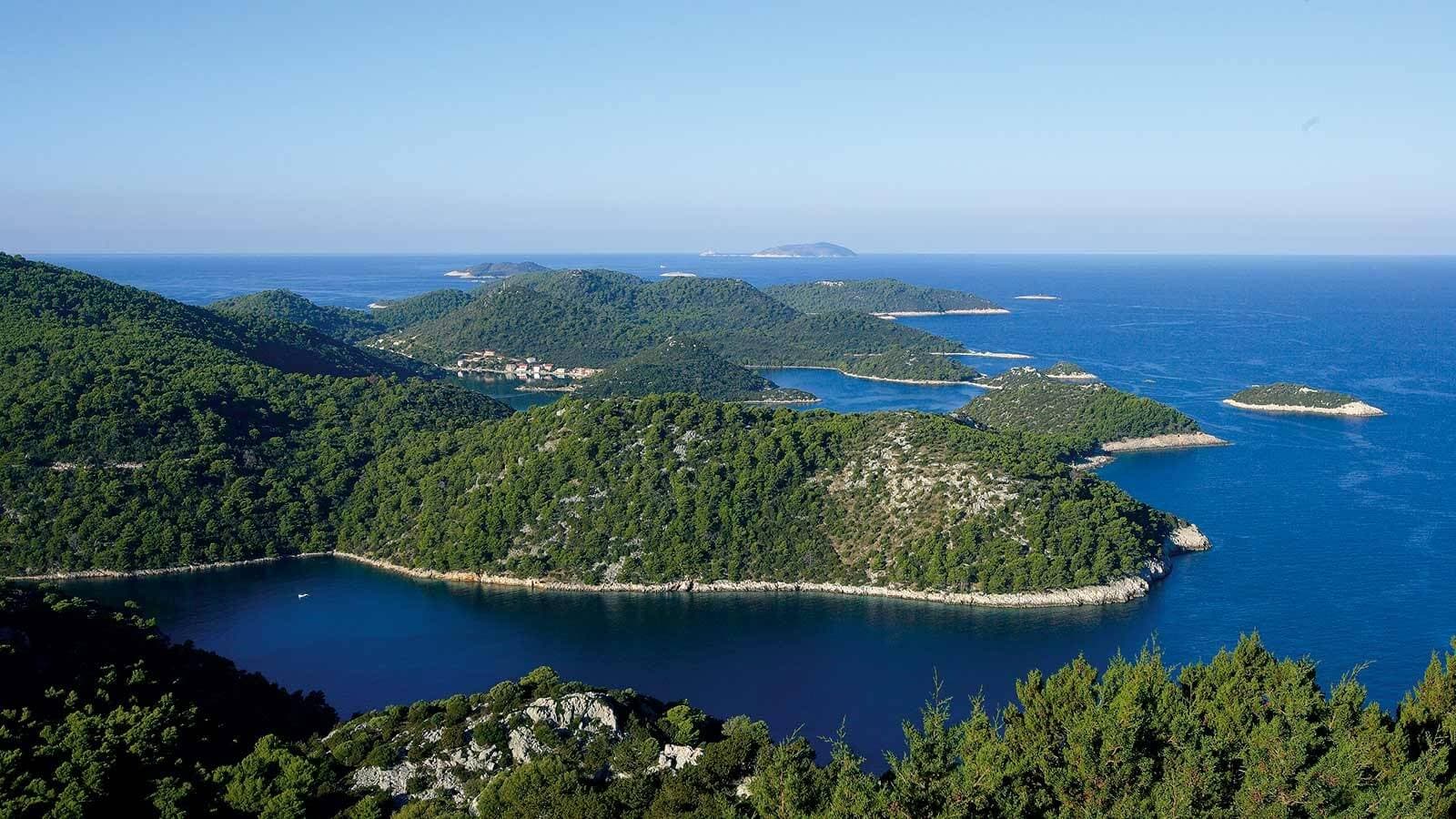 Islands covered with green forests on a deep blue water